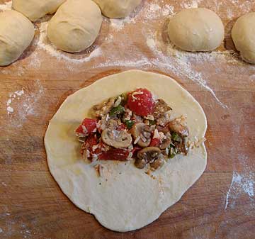 Tomato and Mushroom Filling placement on dough disk for Calzone
